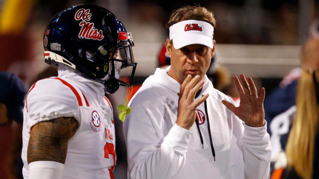 Nov 23, 2023; Starkville, Mississippi, USA; Mississippi Rebels head coach Lane Kiffin (right) talks with defensive back Daijahn Anthony (3) prior to the game against the Mississippi State Bulldogs at Davis Wade Stadium at Scott Field. Mandatory Credit: Petre Thomas-USA TODAY Sports  
